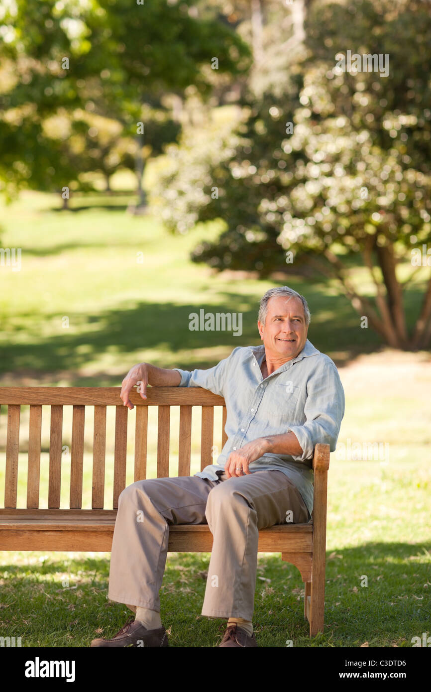 Elderly man sitting on a bench Stock Photo - Alamy
