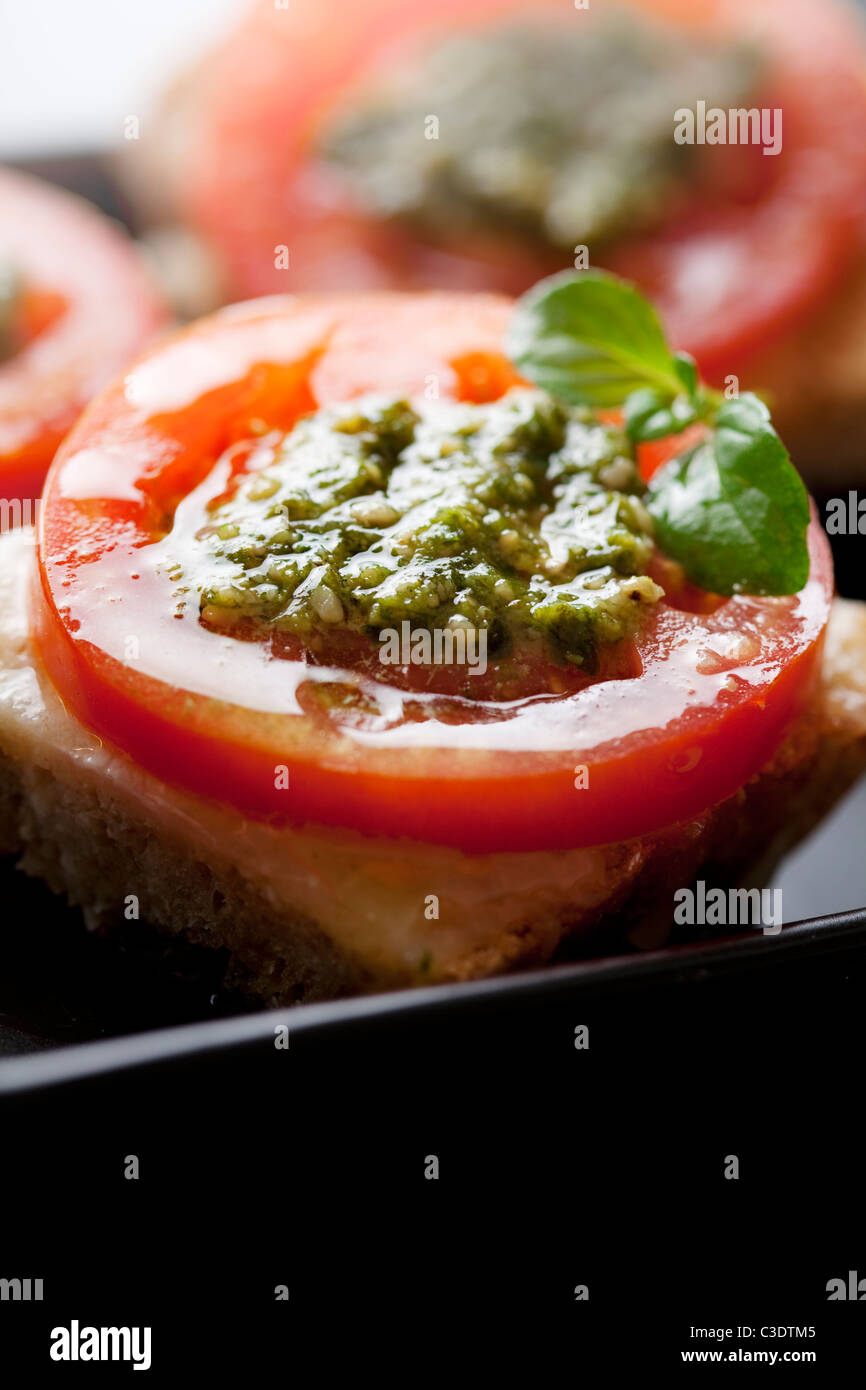 bruschetta with mozzarella, tomato and pesto Stock Photo Alamy