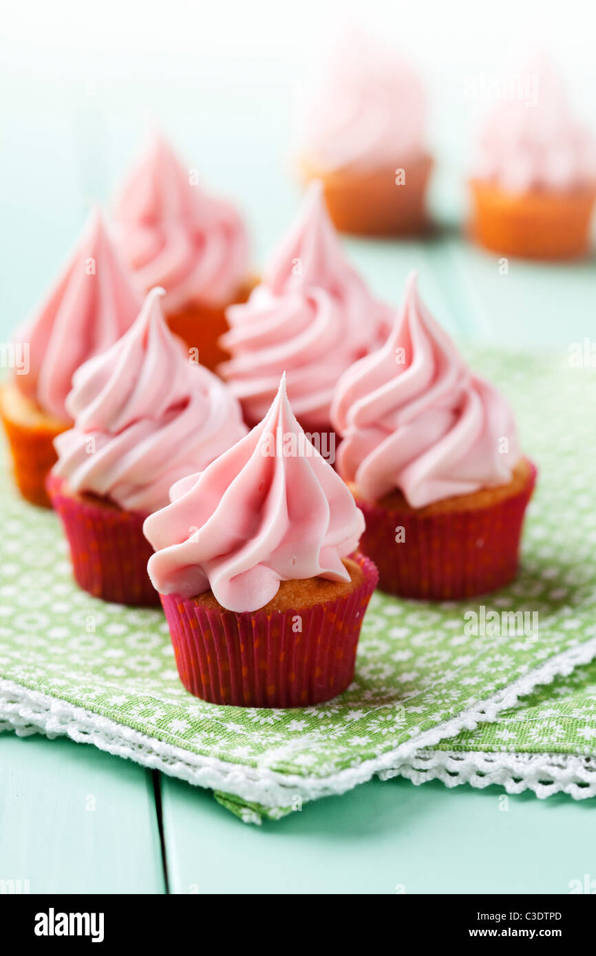 freshly made creamy, pastel pink cupcakes Stock Photo