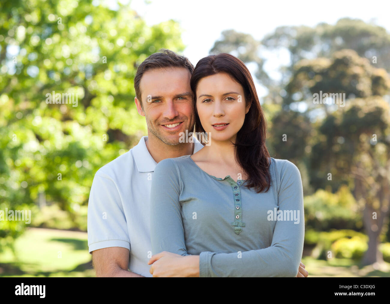 Beautiful couple hugging in the park Stock Photo - Alamy