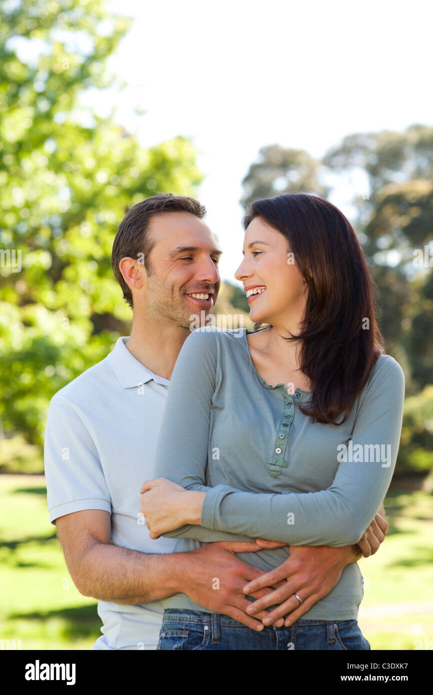 Beautiful couple hugging in the park Stock Photo - Alamy