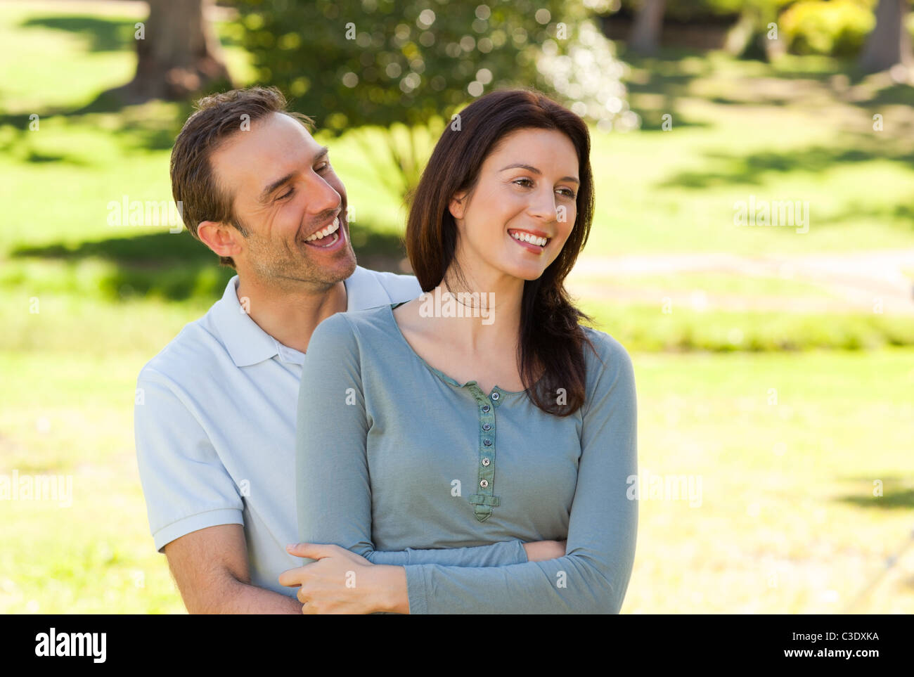 Beautiful couple hugging in the park Stock Photo - Alamy