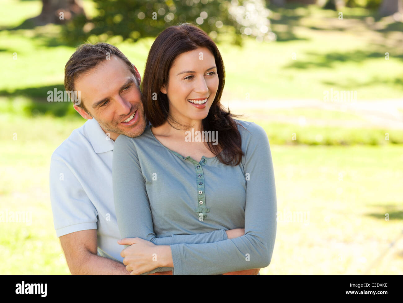 Beautiful couple hugging in the park Stock Photo - Alamy