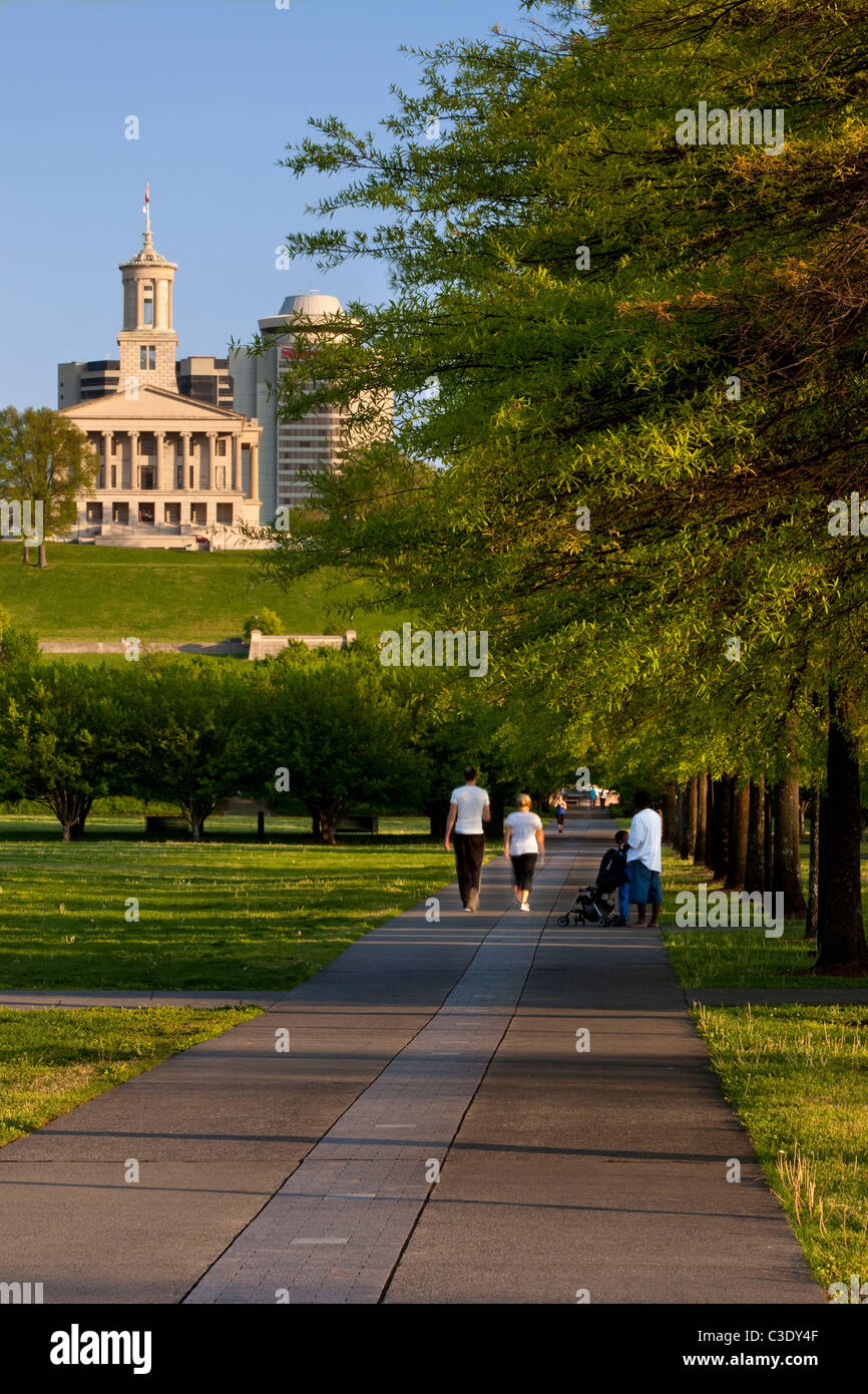 Families enjoying a spring walk through Bicentennial Park below the Capitol Building in Nashville Tennessee USA Stock Photo