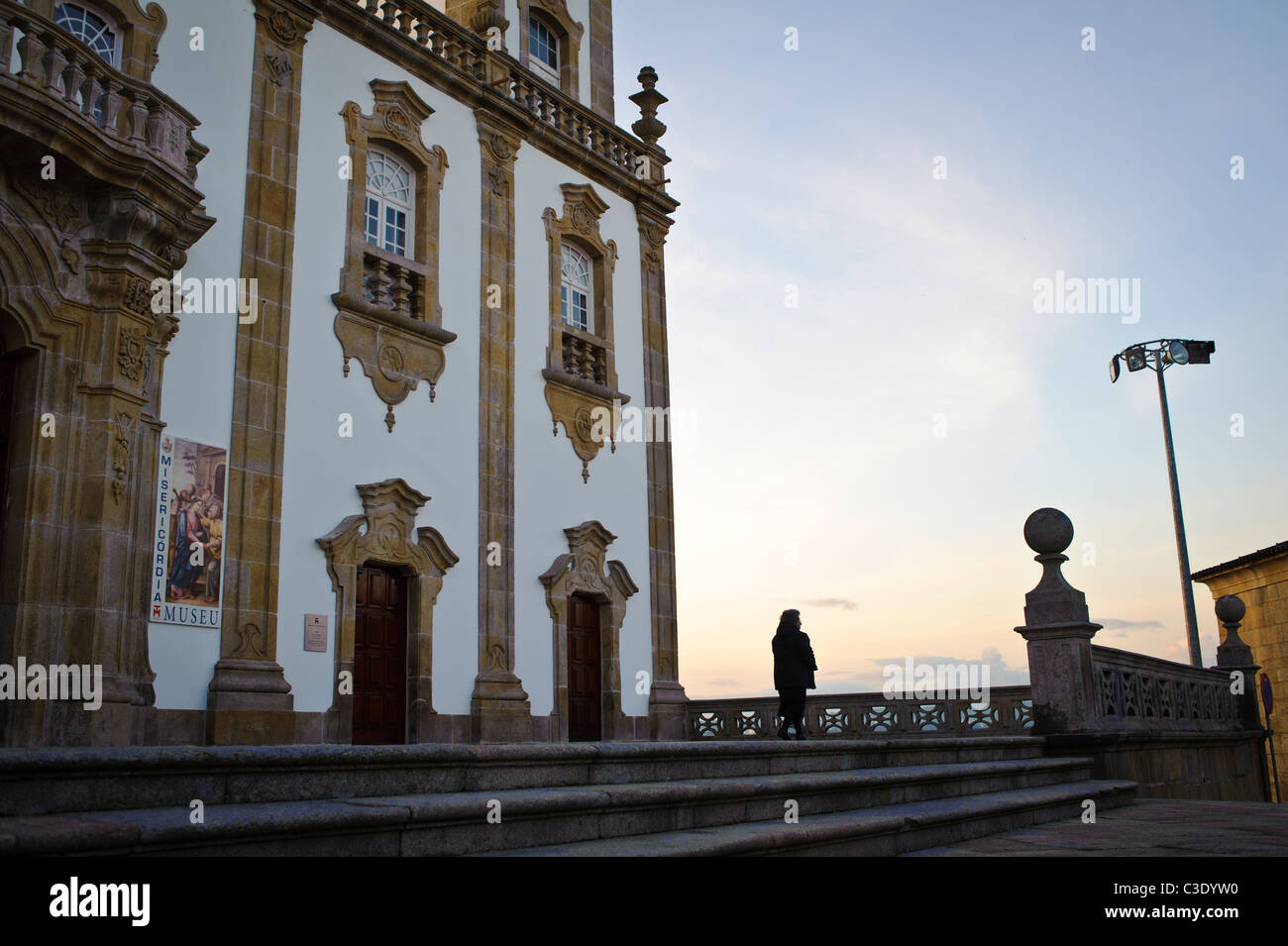 Woman in silhouette watching sunset in Viseu Portugal Stock Photo