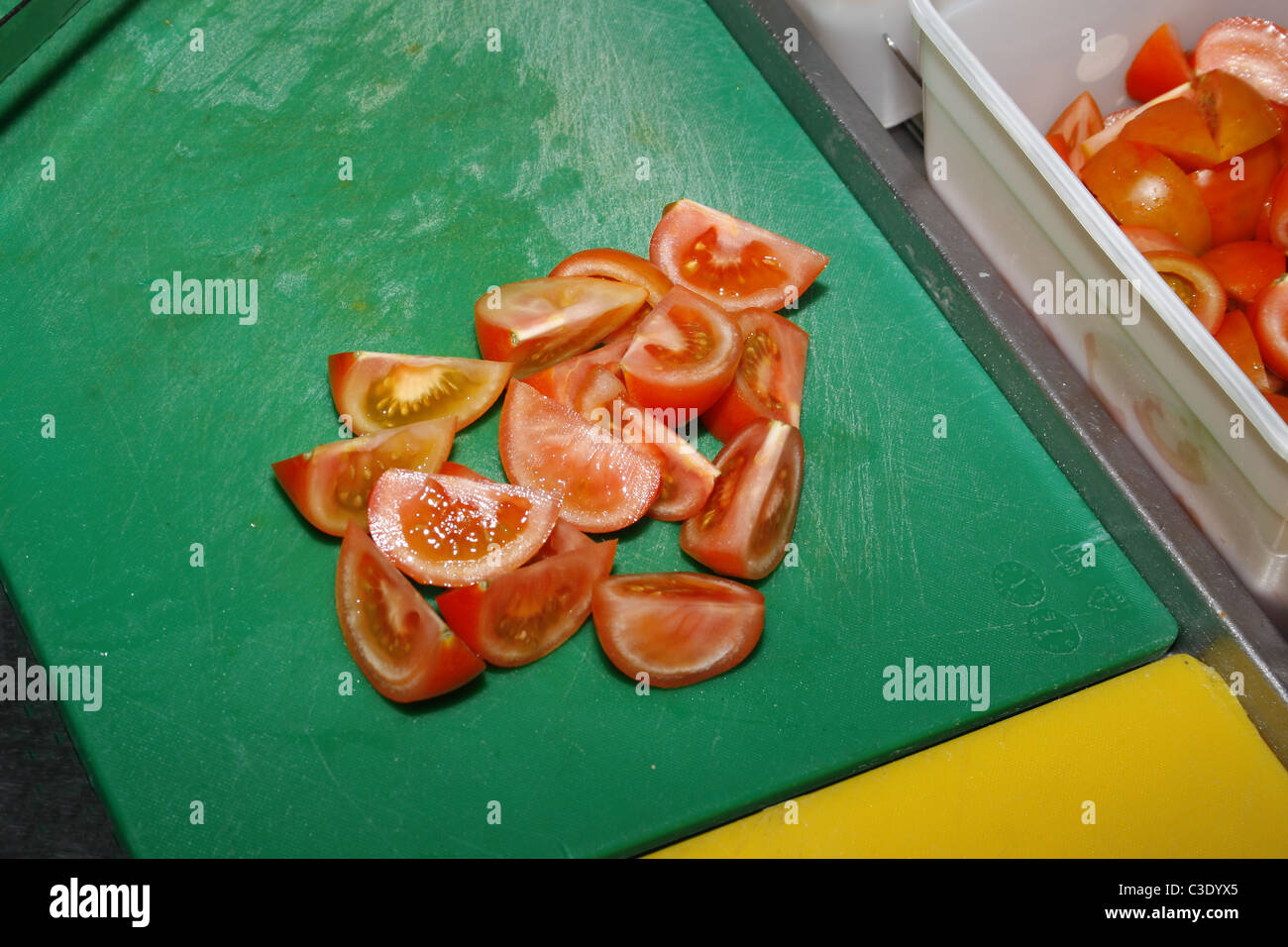 sliced tomatoes on green chopping board in kitchen Stock Photo - Alamy