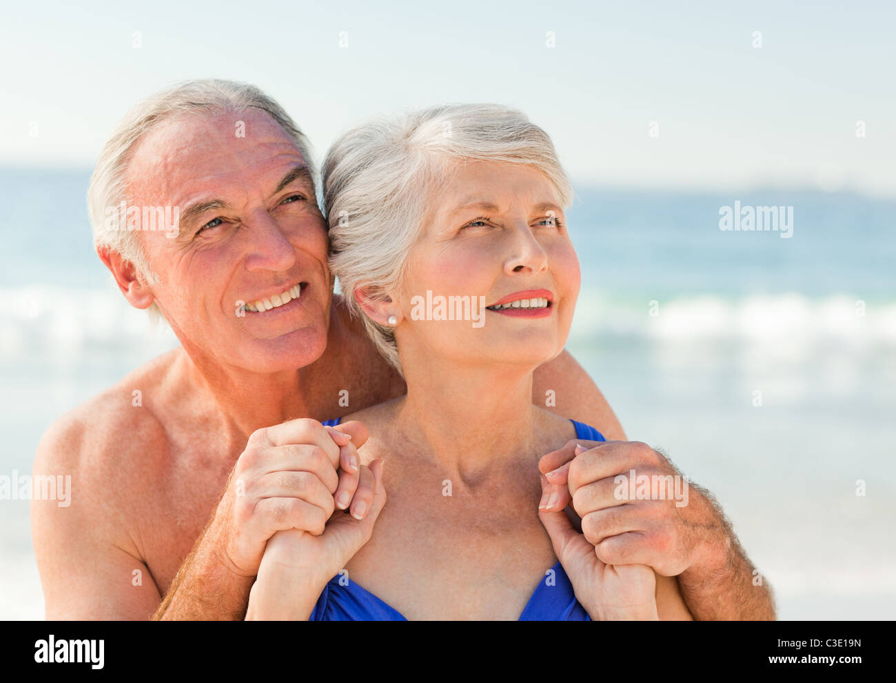 Man hugging his wife at the beach Stock Photo Alamy