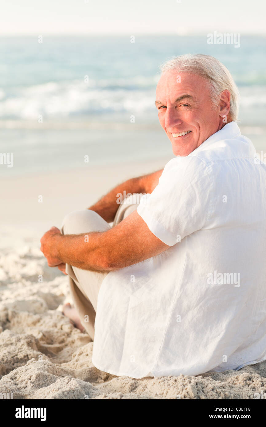 Lonely man sitting on beach hi-res stock photography and images - Alamy