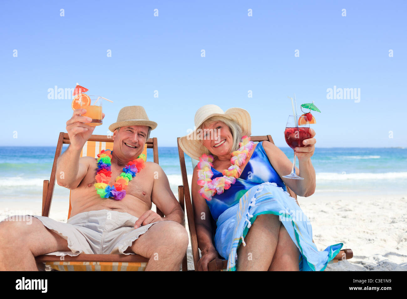Mature couple sitting on deck chairs Stock Photo - Alamy