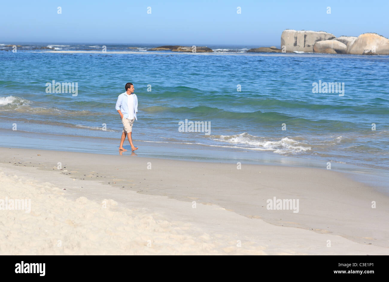 Man walking on the beach Stock Photo - Alamy