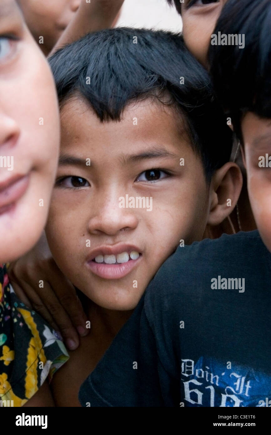 A group of playful young Asian boys living in poverty are enjoying ...