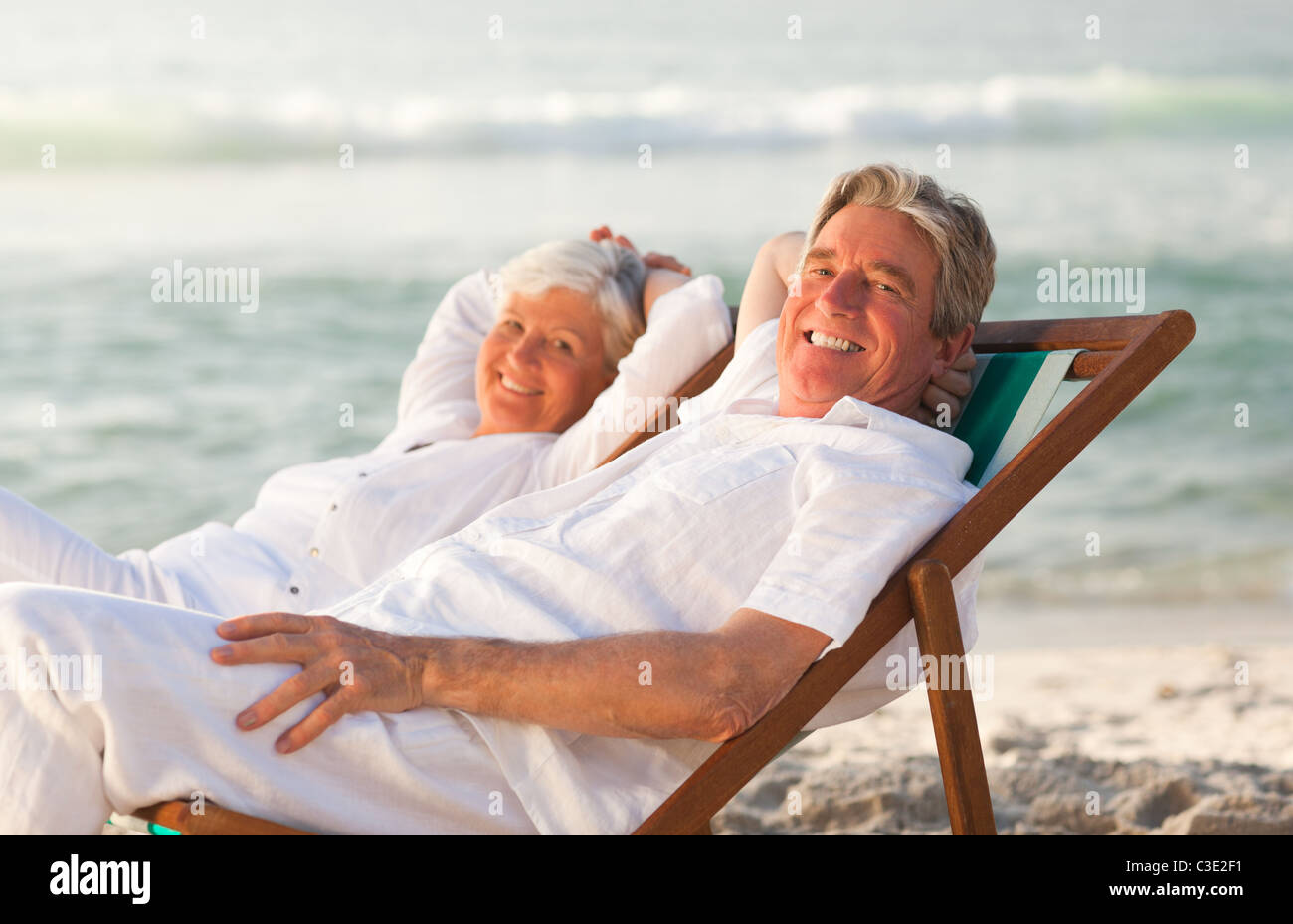 Elderly couple relaxing in their deck chairs Stock Photo - Alamy