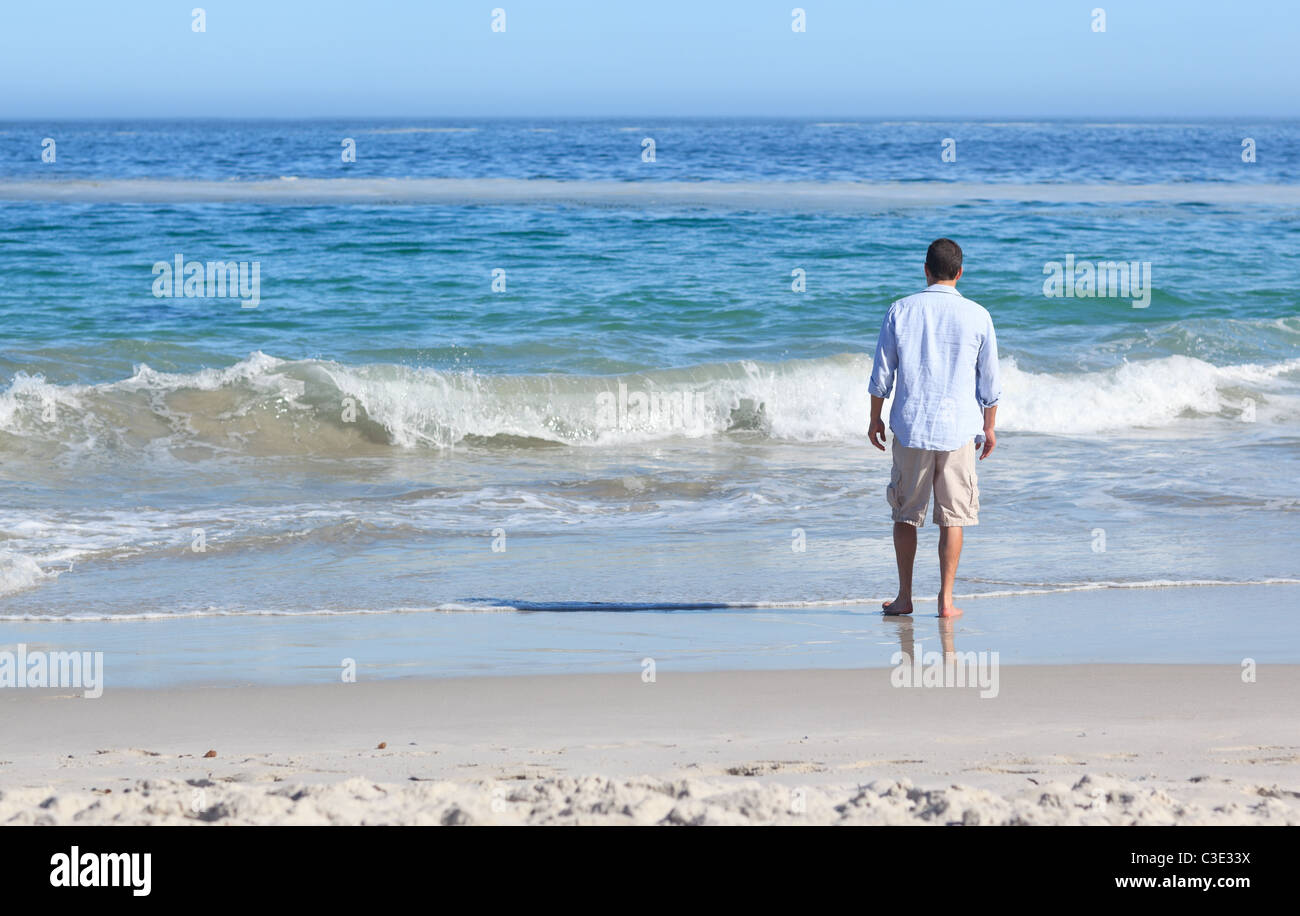Man walking on the beach Stock Photo - Alamy
