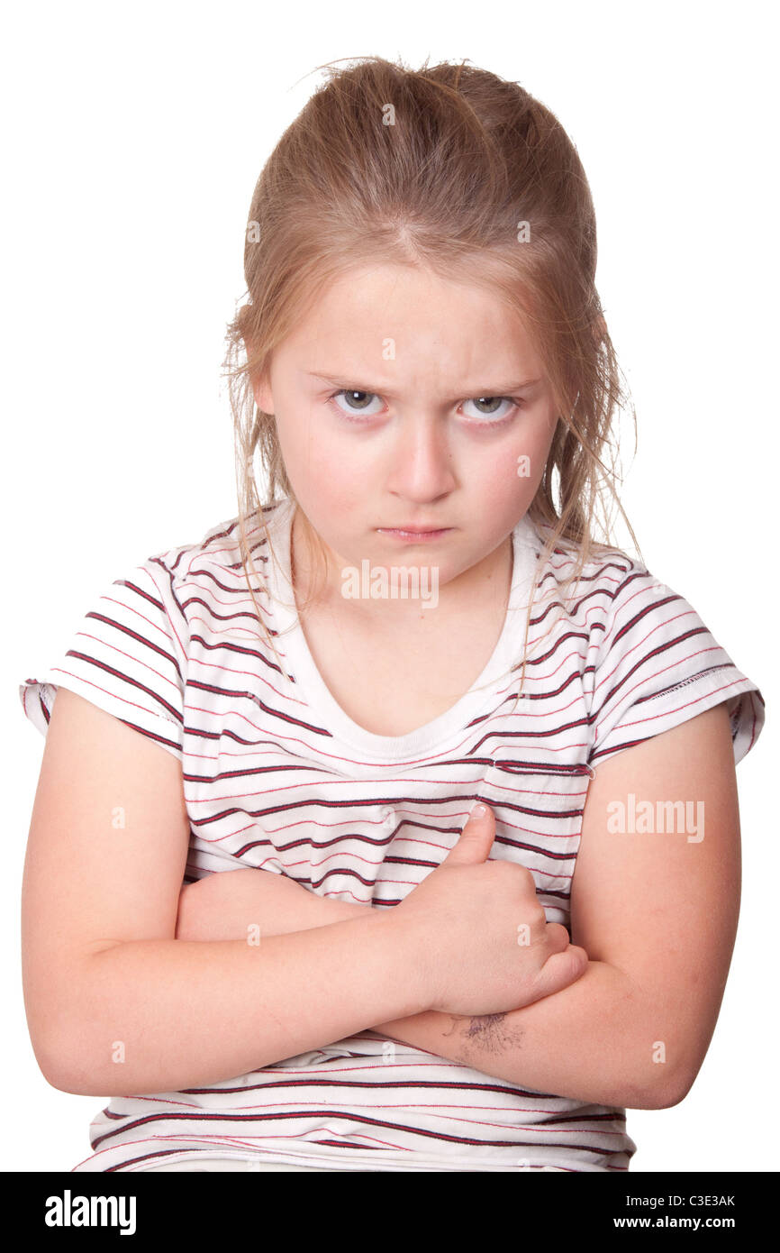 A photograph of a young girl with her arms crossed and very mad. Stock Photo
