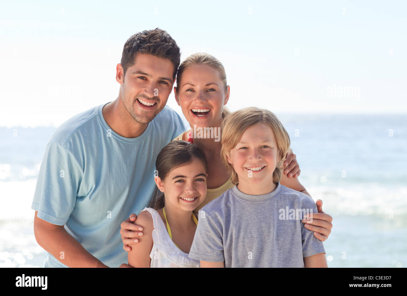 Joyful family at the beach Stock Photo