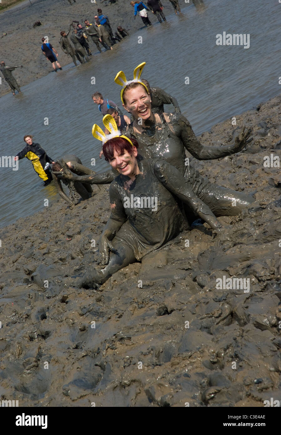 two female mud runners play around in the maldon mud Stock Photo