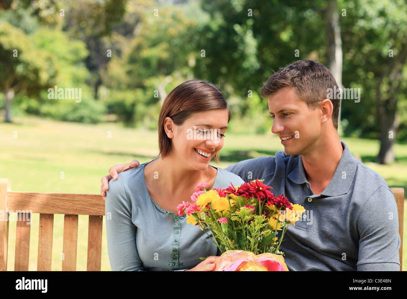 Man offering flowers to his girlfriend Stock Photo