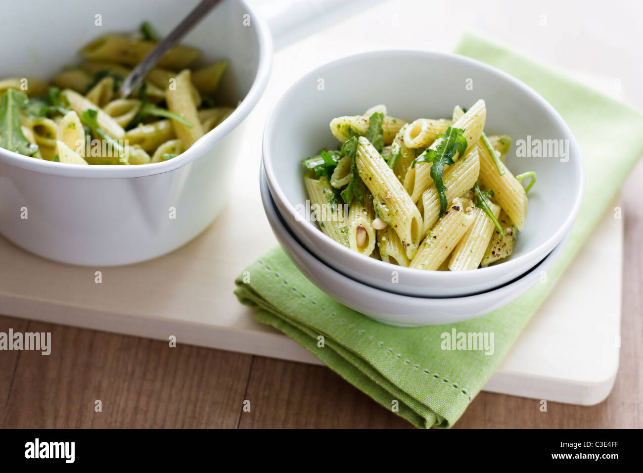 Rigatoni with home made rocket pesto, served in a white bowl. Stock Photo