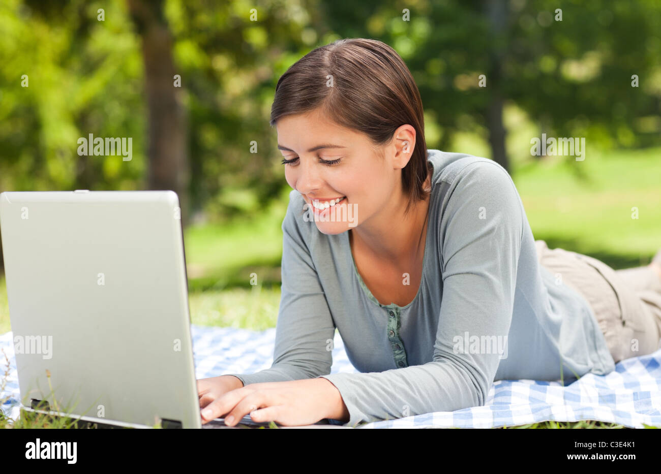 Woman working on her laptop in the park Stock Photo - Alamy