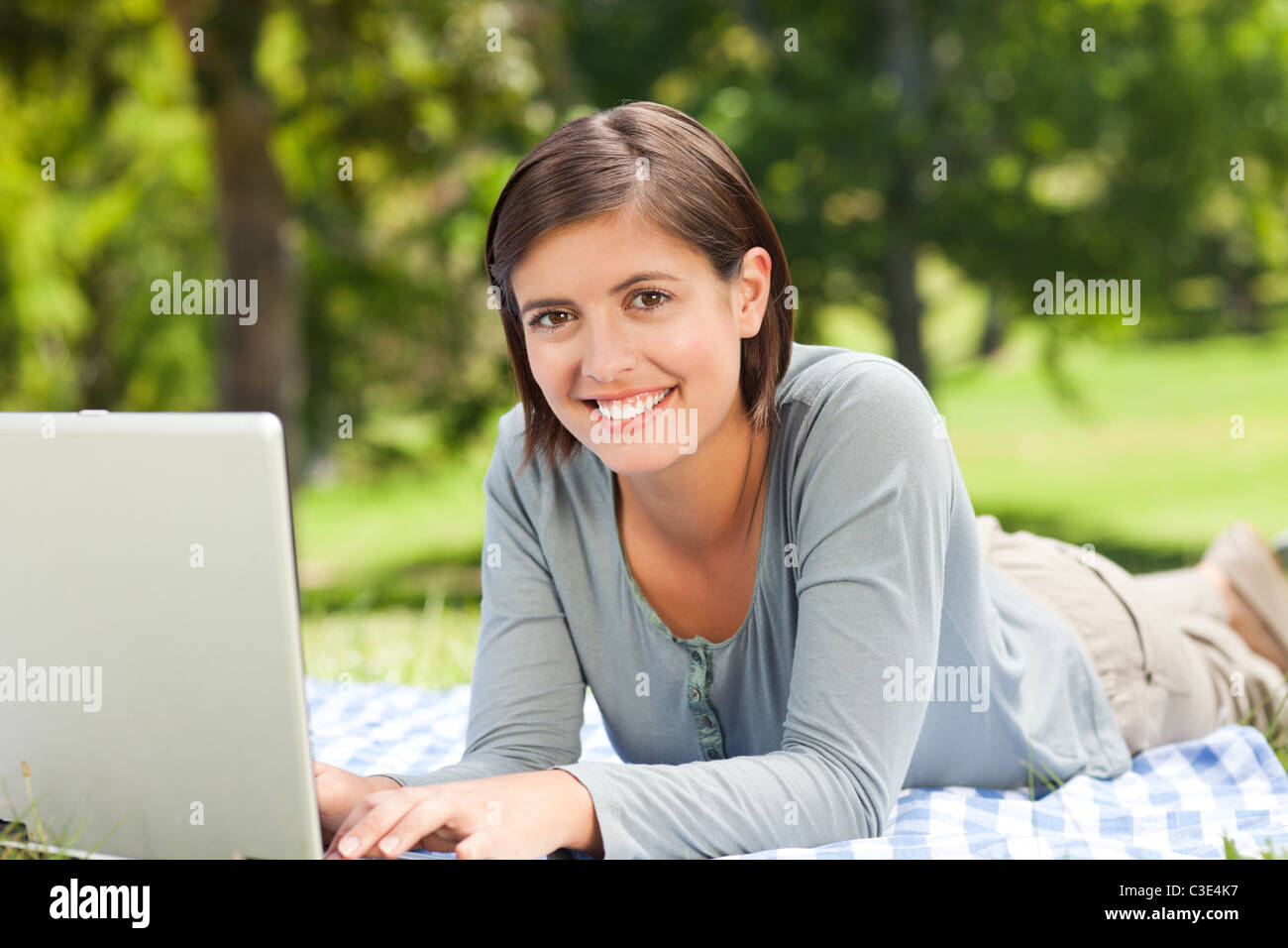 Woman working on her laptop in the park Stock Photo - Alamy