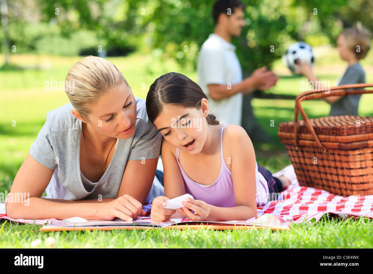 Happy family picnicking in the park Stock Photo - Alamy