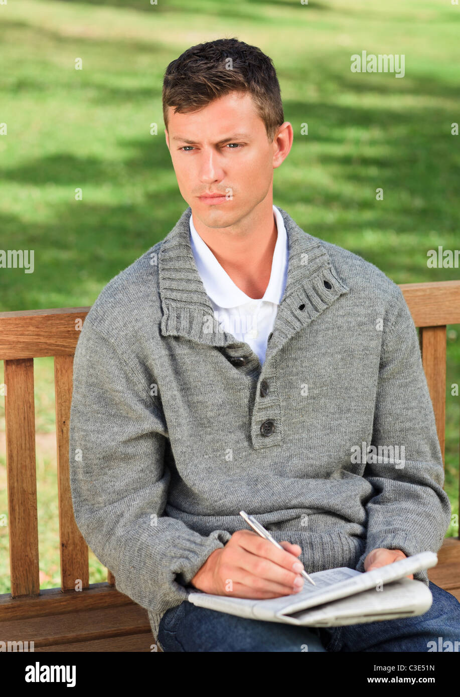 Handsome man making his crossword Stock Photo Alamy Handsome man making his crossword Stock Photo Alamy