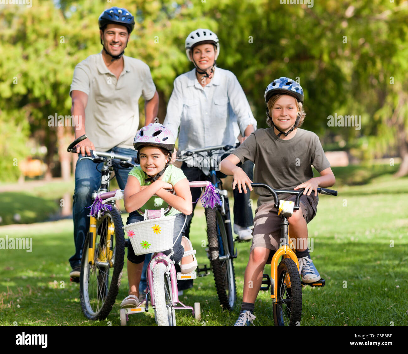 Family with their bikes in a park Stock Photo - Alamy
