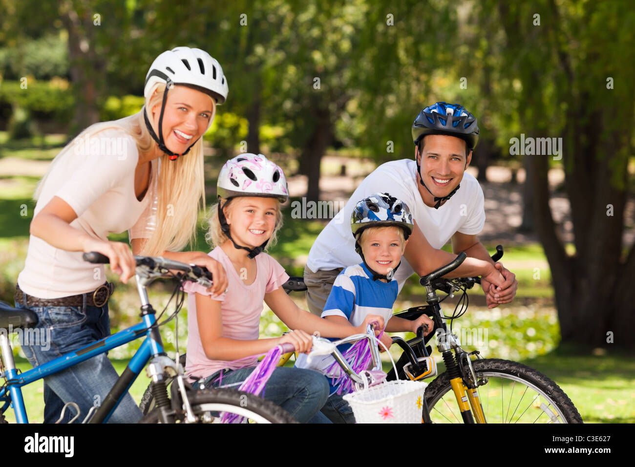 Family in the park with their bikes Stock Photo - Alamy