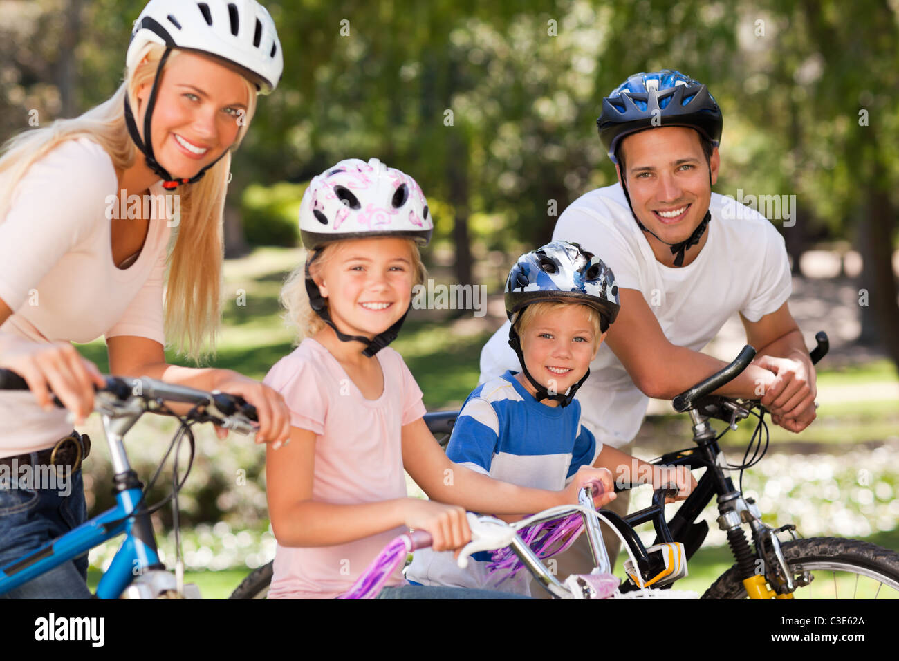 Family in the park with their bikes Stock Photo - Alamy