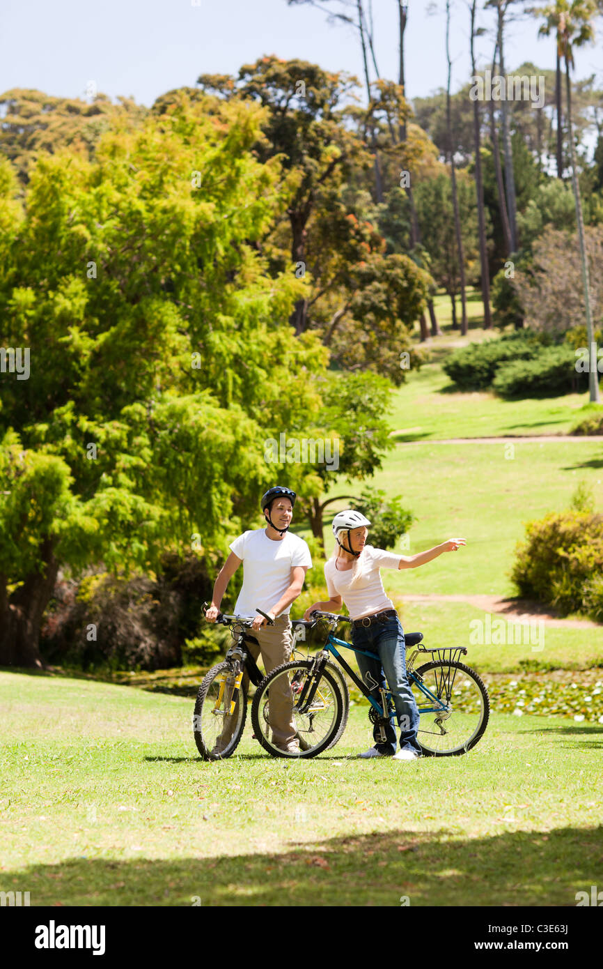 Couple with their bikes in the park Stock Photo - Alamy