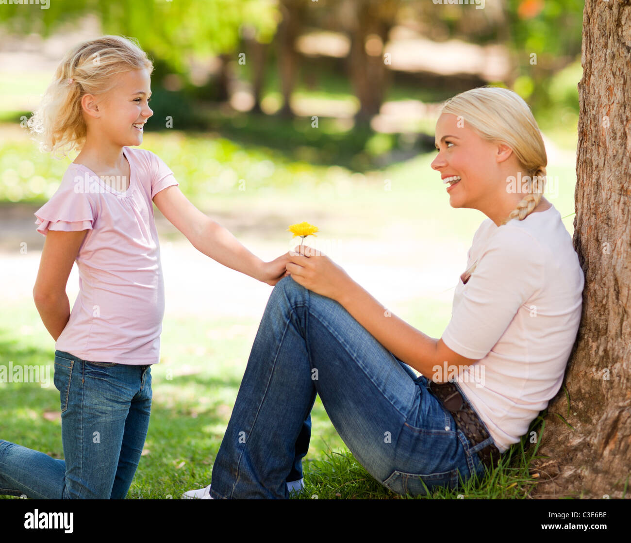 Daughter offering a flower to her mother Stock Photo Alamy