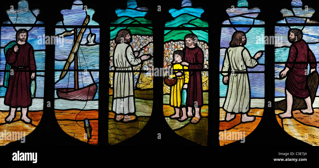 Modern stained glass windows depicting 'the feeding of the five thousand', Brinton, Norfolk, England Stock Photo