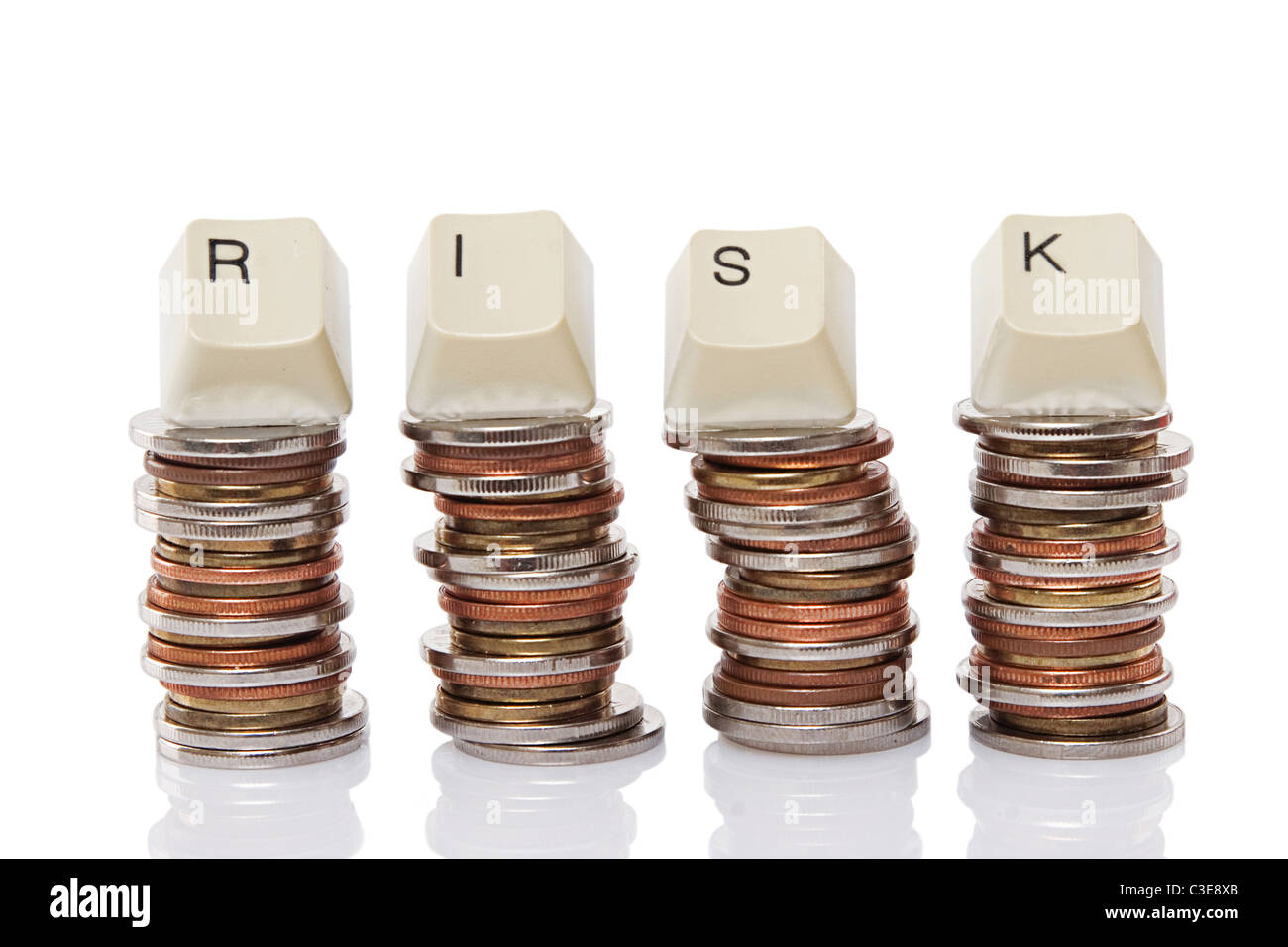 Keyboard Letter Spelling Risk Atop Coin Stacks Stock Photo