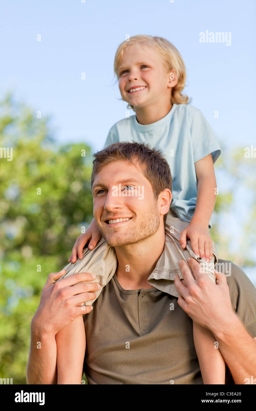 Father giving son a piggyback Stock Photo - Alamy