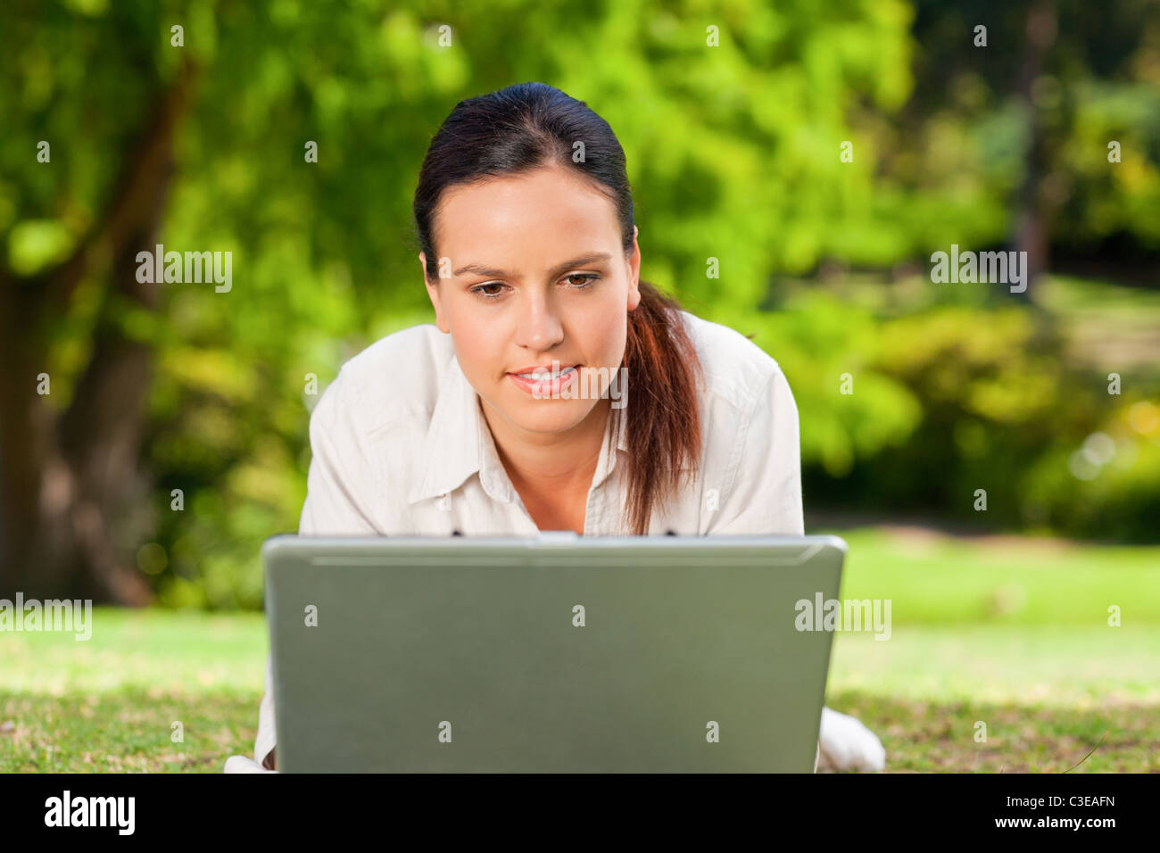 Young woman working on her laptop Stock Photo - Alamy