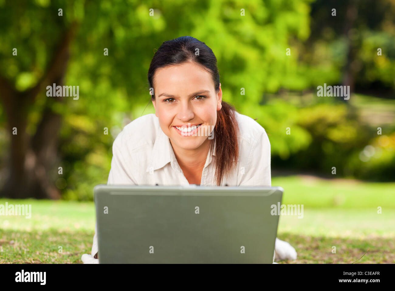 Young woman working on her laptop Stock Photo - Alamy