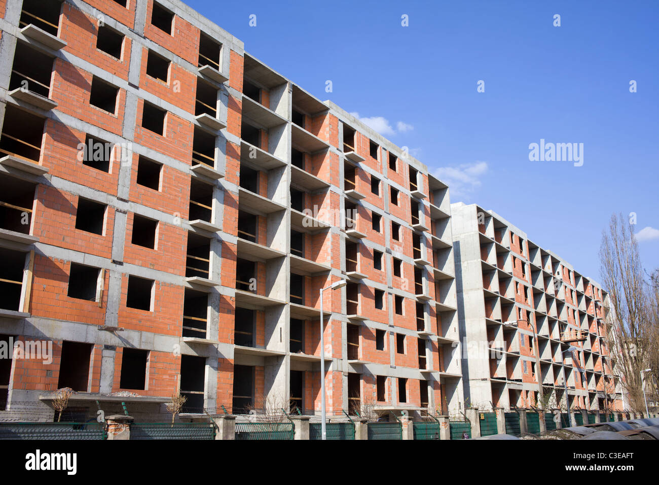 Apartment block with concrete frame and brick walls under Stock Photo