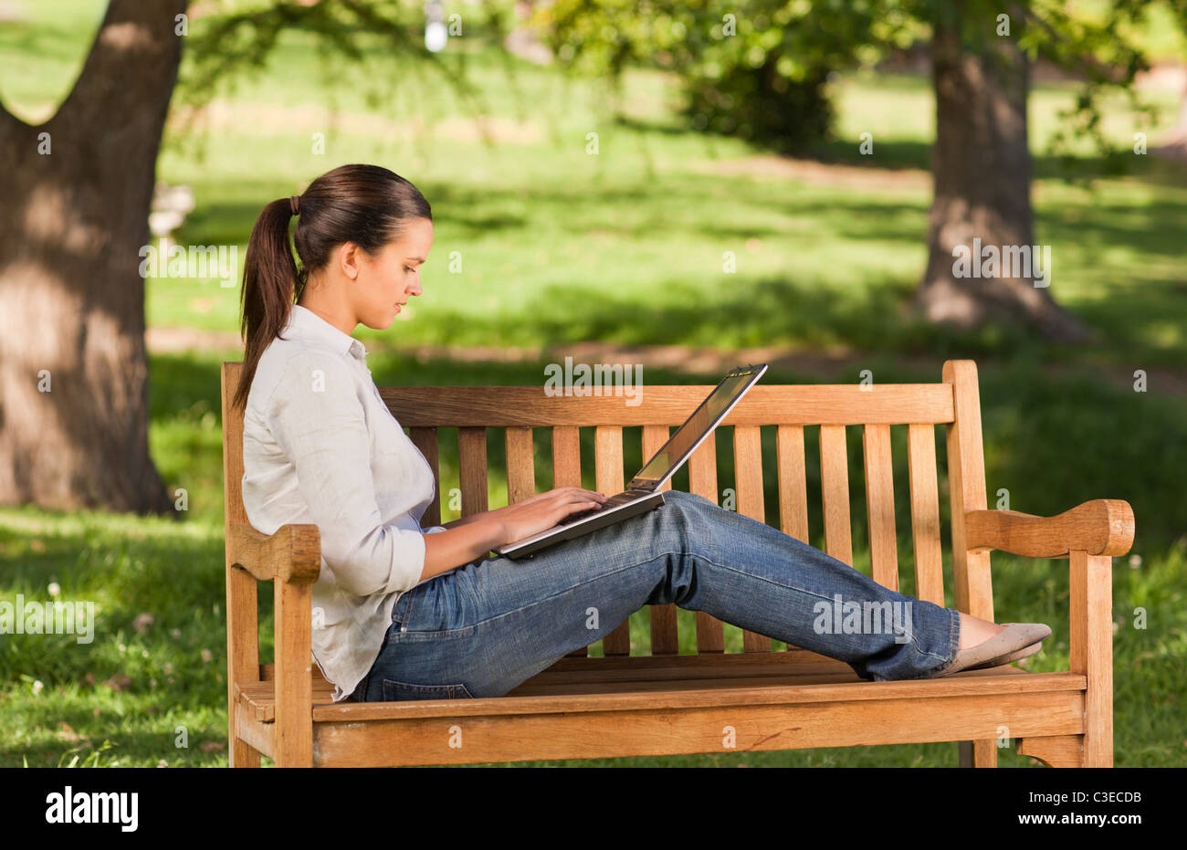 Young woman working on her laptop Stock Photo - Alamy