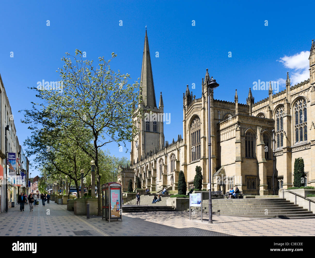Wakefield Cathedral and shops along Kirkgate/Westgate in the city centre, Wakefield, West Yorkshire, UK Stock Photo
