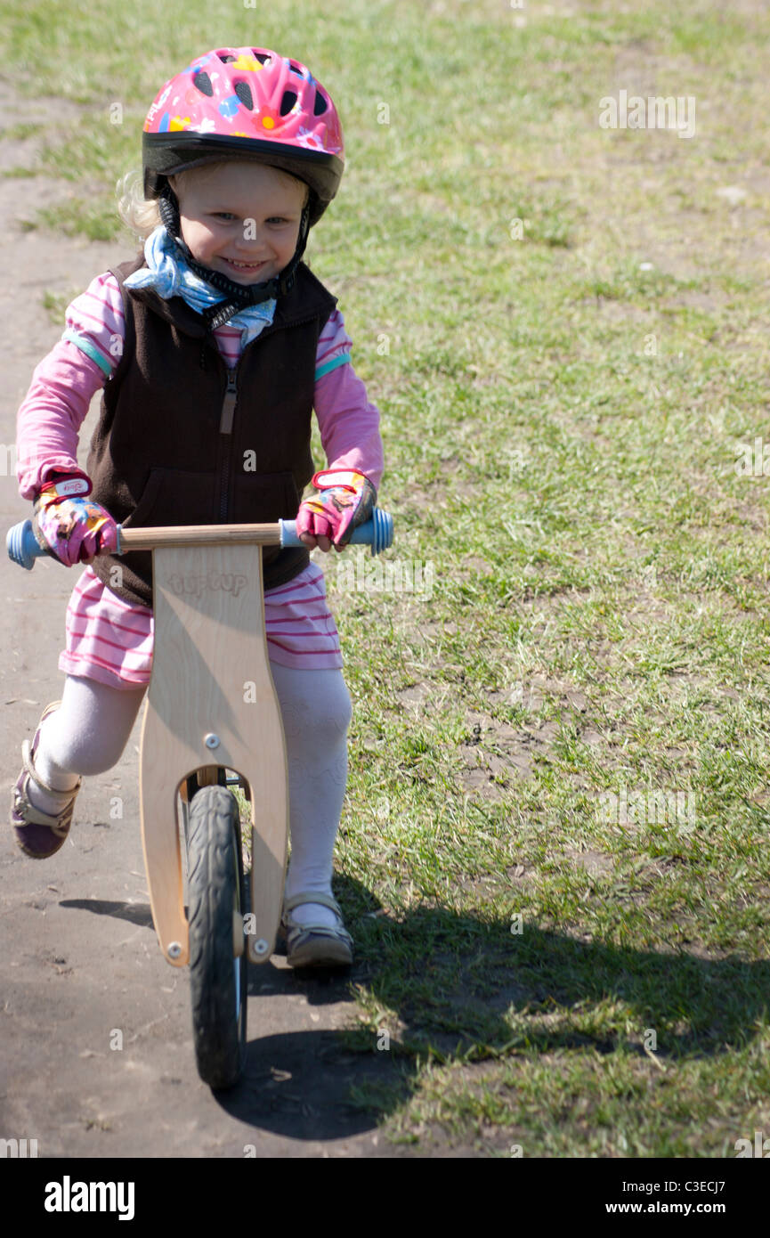 Two and half years old girl ride a bicycle without foot lever (balance
