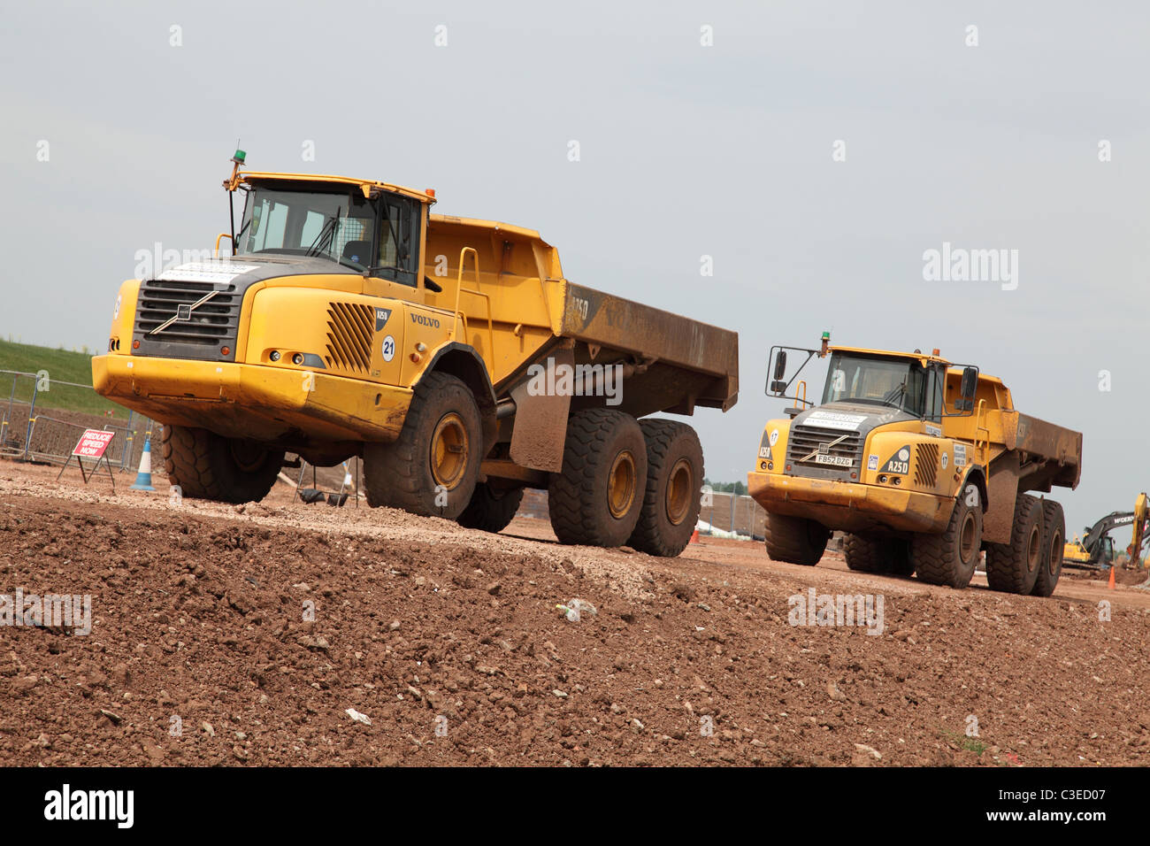 Volvo tipper trucks on the site of the A46 road widening scheme in Nottinghamshire, England, U.K. Stock Photo