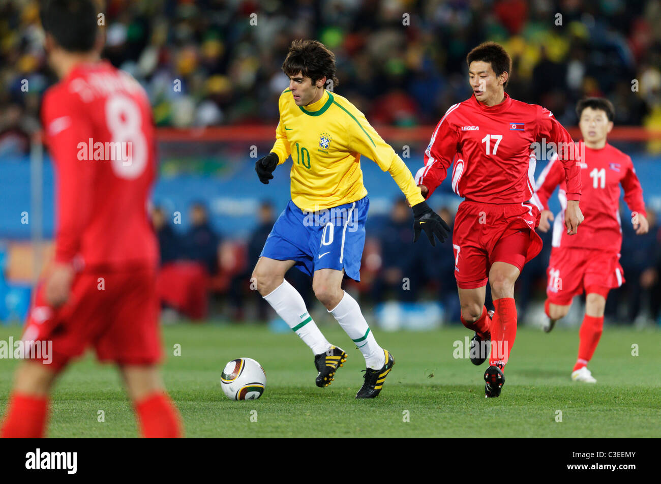 Kaka of Brazil (10) controls the ball against Yong Hak An of North Korea (17) during a 2010 FIFA World Cup football match. Stock Photo