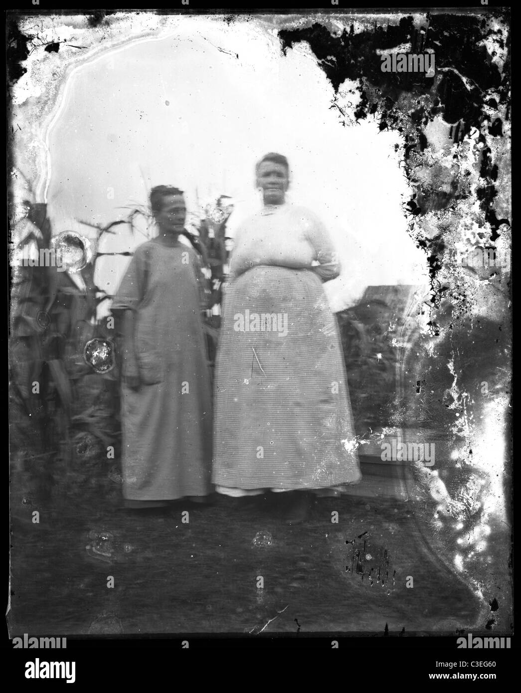 two women in dresses near cornfield farmers 1890s Stock Photo