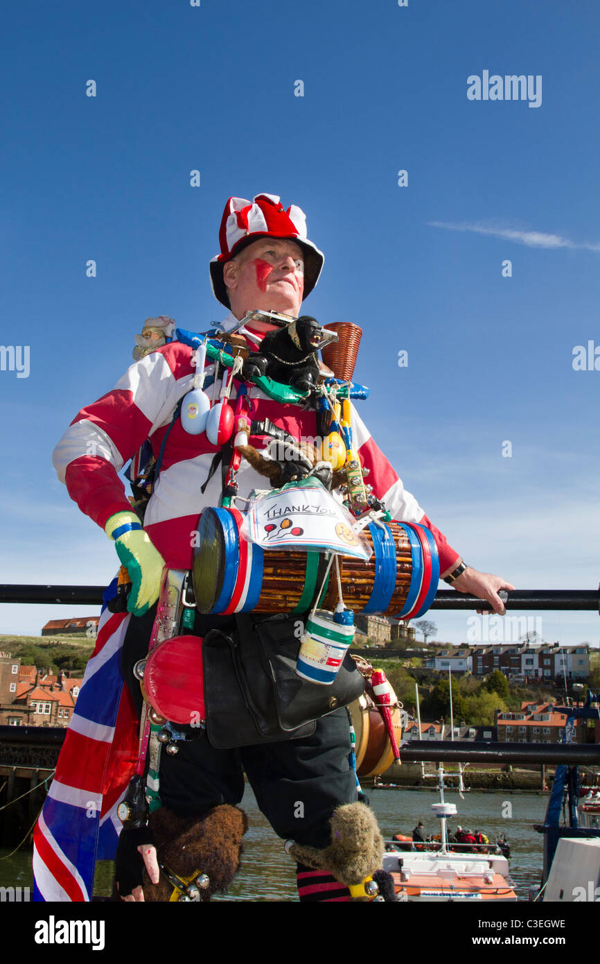 Quirky Oddball, Eccentric Street Musician, Busker & travelling entertainer. Victorian one man band playing drums in fancy dress, Whitby UK Stock Photo