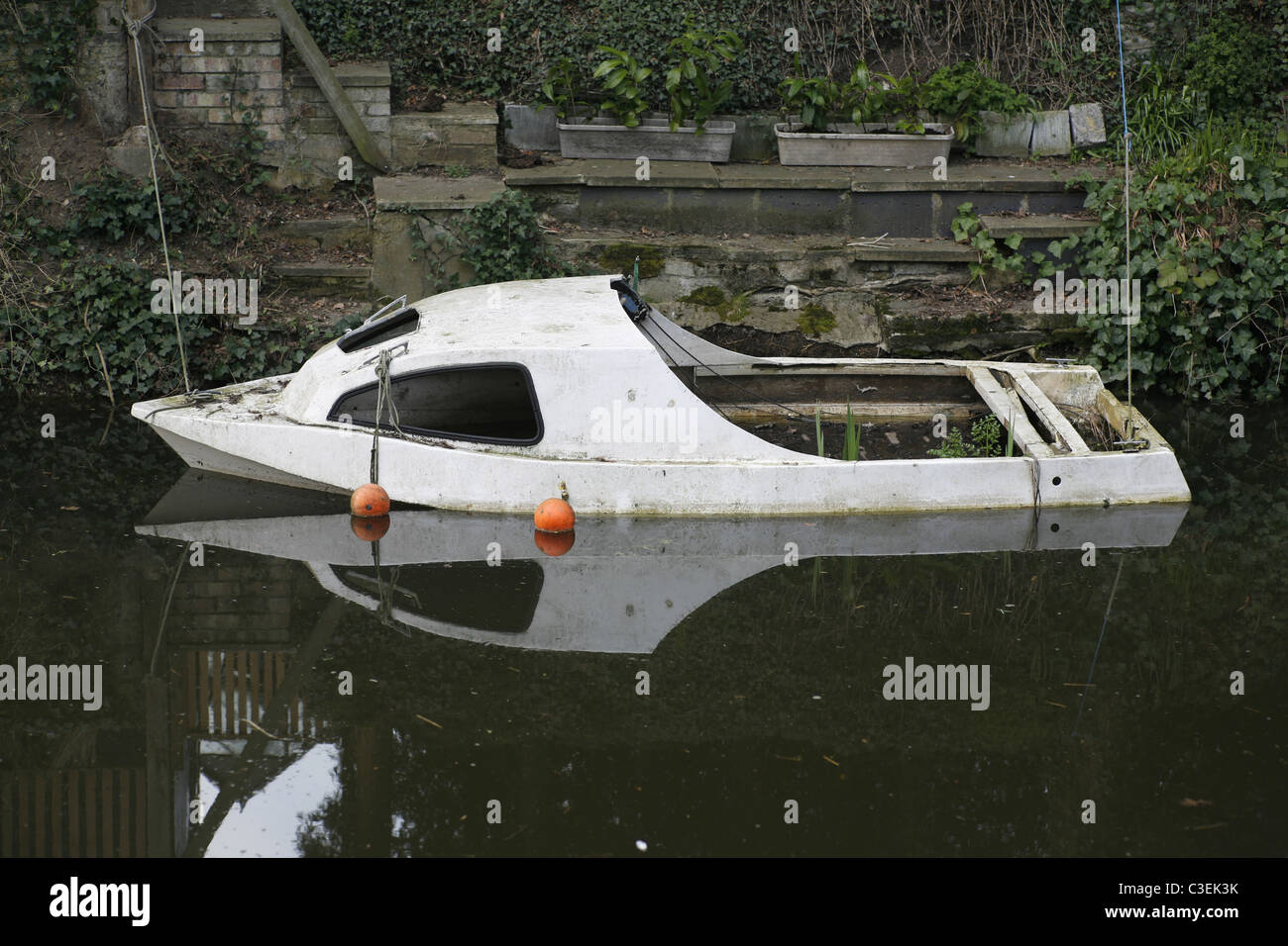 Abandoned boat half sunken Basingstoke Canal Woking Surrey England Stock Photo