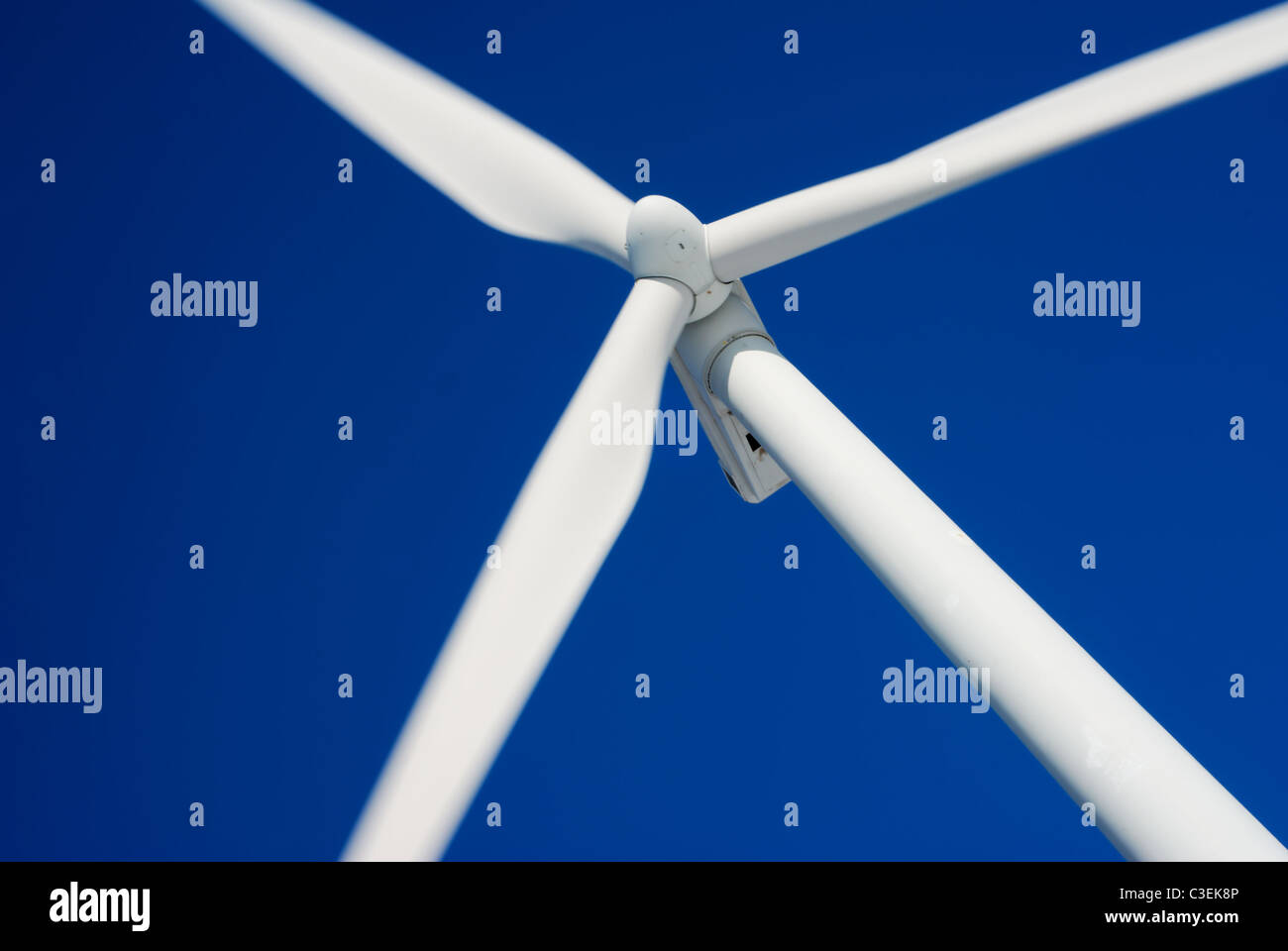 Close-up of moving wind turbine with deep blue sky Stock Photo