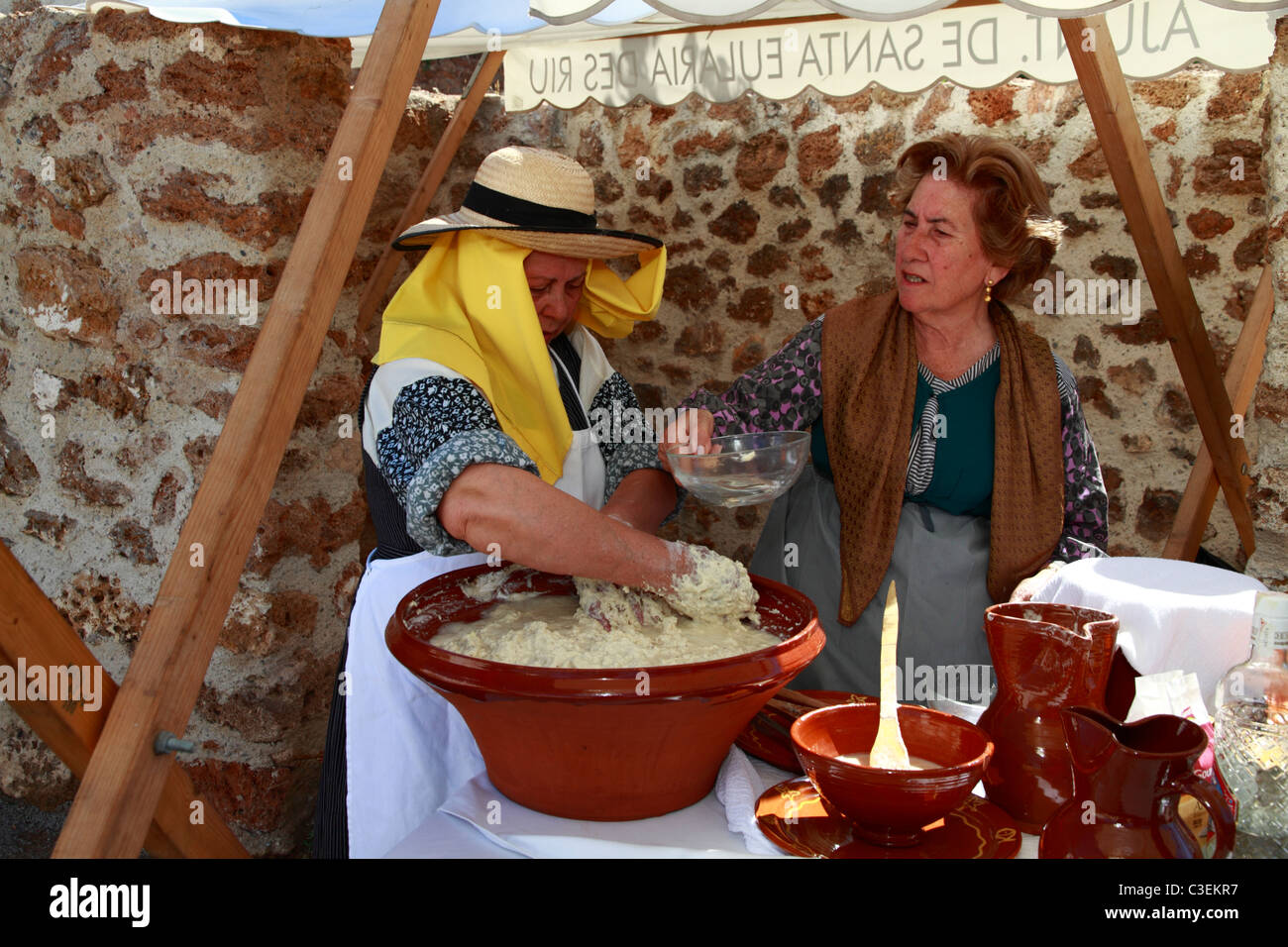 Ladies in traditional costume baking at a Handicraft Fair, Ibiza, Spain Stock Photo
