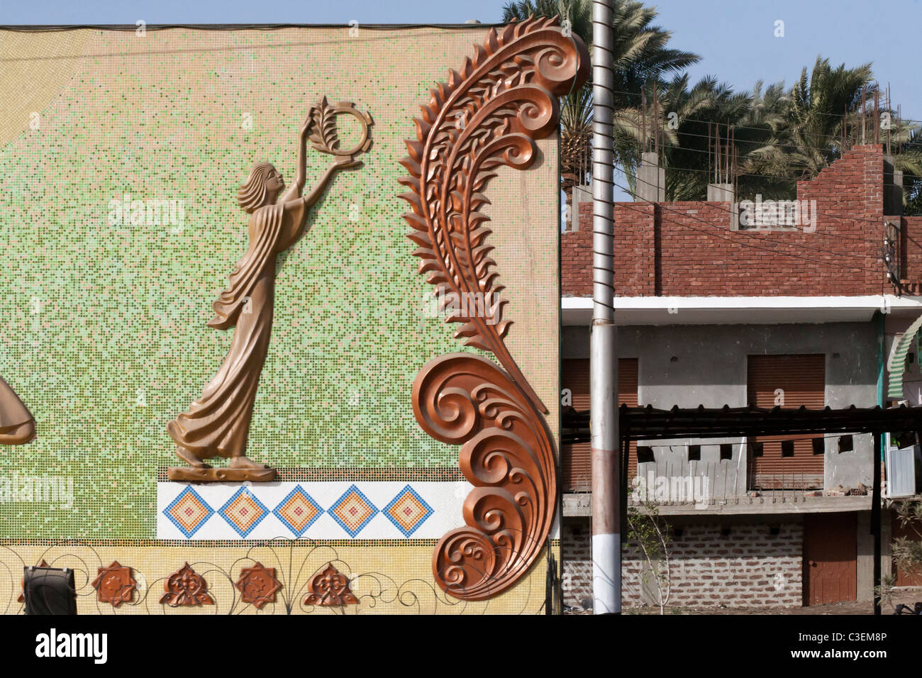Elaborate wall detail with concrete scrolls and mosiac design on a building in Egyptian city, Africa Stock Photo