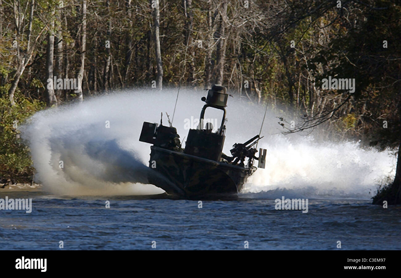 Members of Special Boat Team 22 of US Navy SEALS practice narrow river beach extractions under hostile fire conditions. Stock Photo