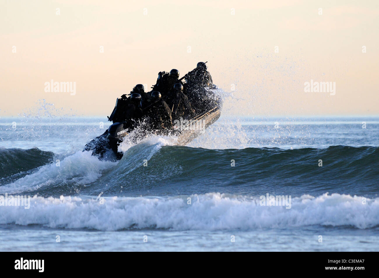 US Navy SEAL team members navigate the surf off the cost of Coronado